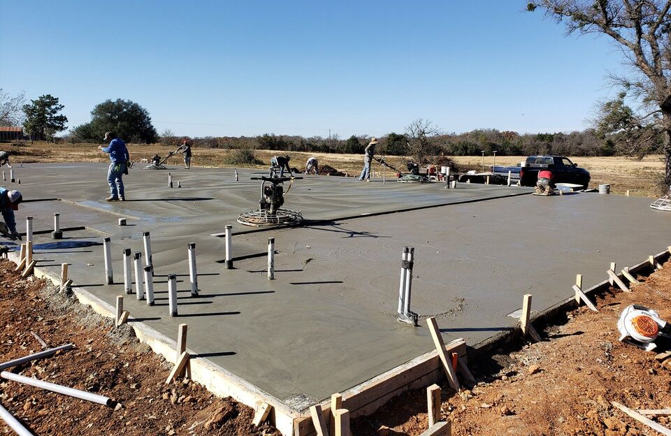 Crew finishing a concrete slab in Central Texas