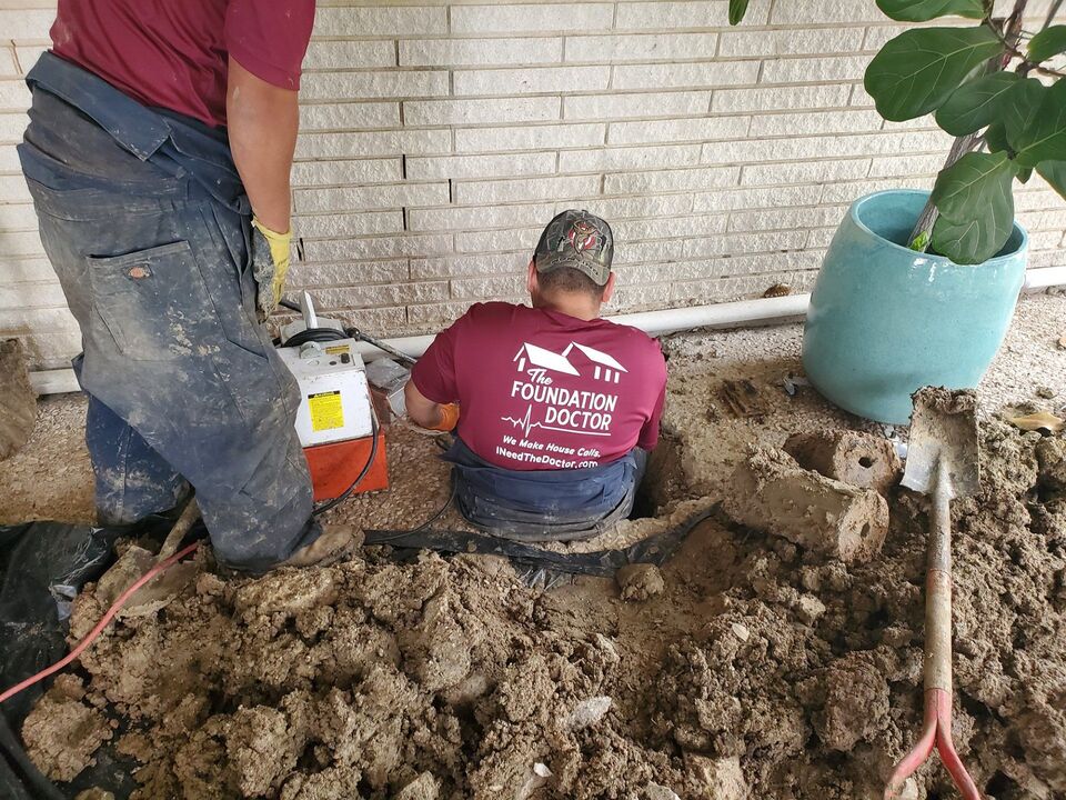 The Foundation Doctor crew at work on a brick home foundation