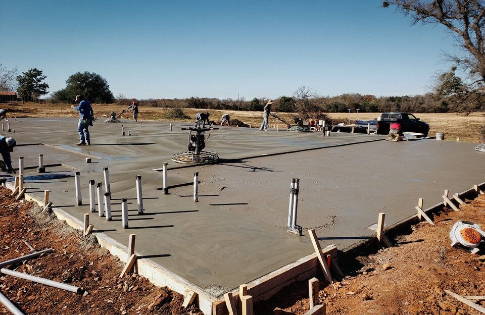 Foundation crew finishing concrete at a leveling job in Central Texas