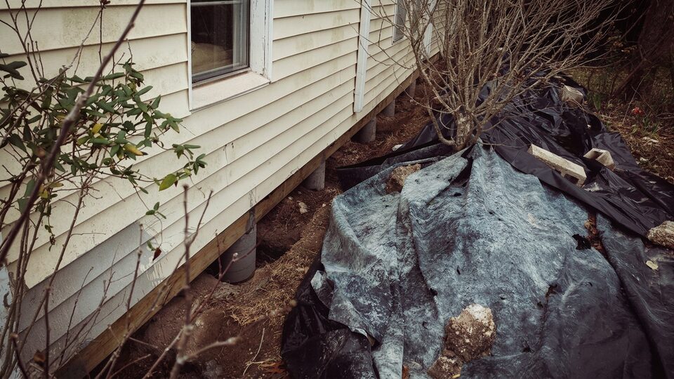 Pier row exposed beneath a house during leveling