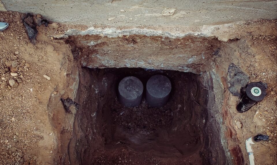 Pressed concrete pier stack beneath a slab foundation
