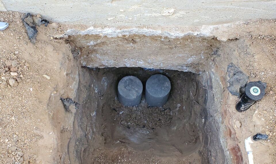 Pressed concrete pier stack installed beneath a settled slab