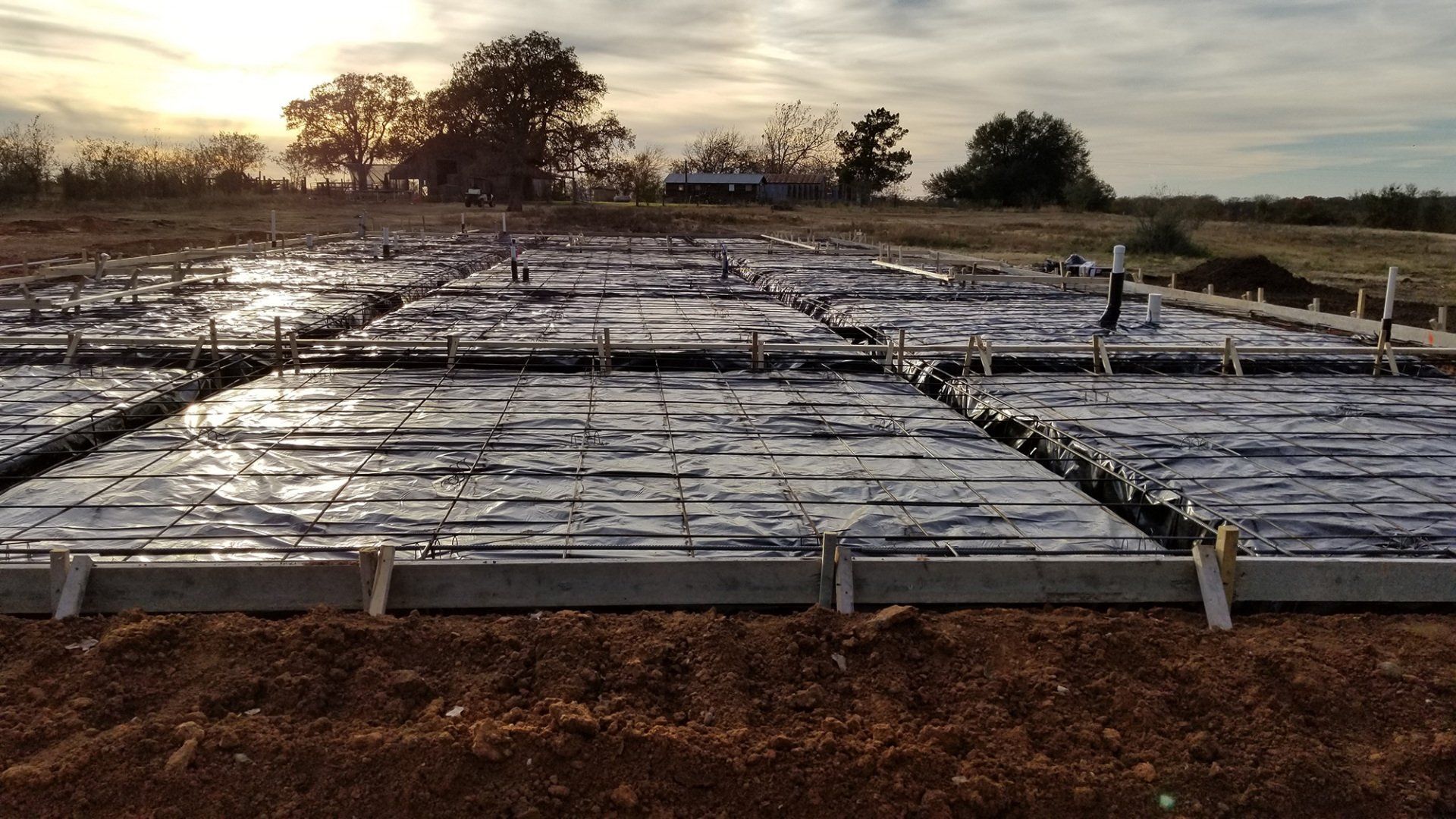 Building pad and rebar grid at sunset outside McGregor, Texas