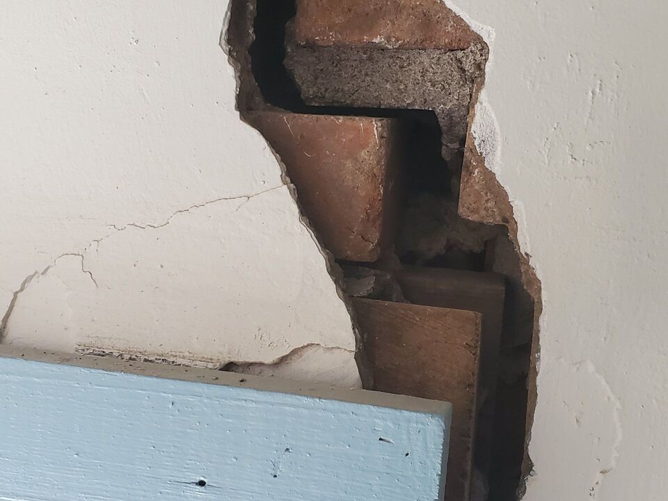 Stair-step crack through interior drywall of an unlevel house