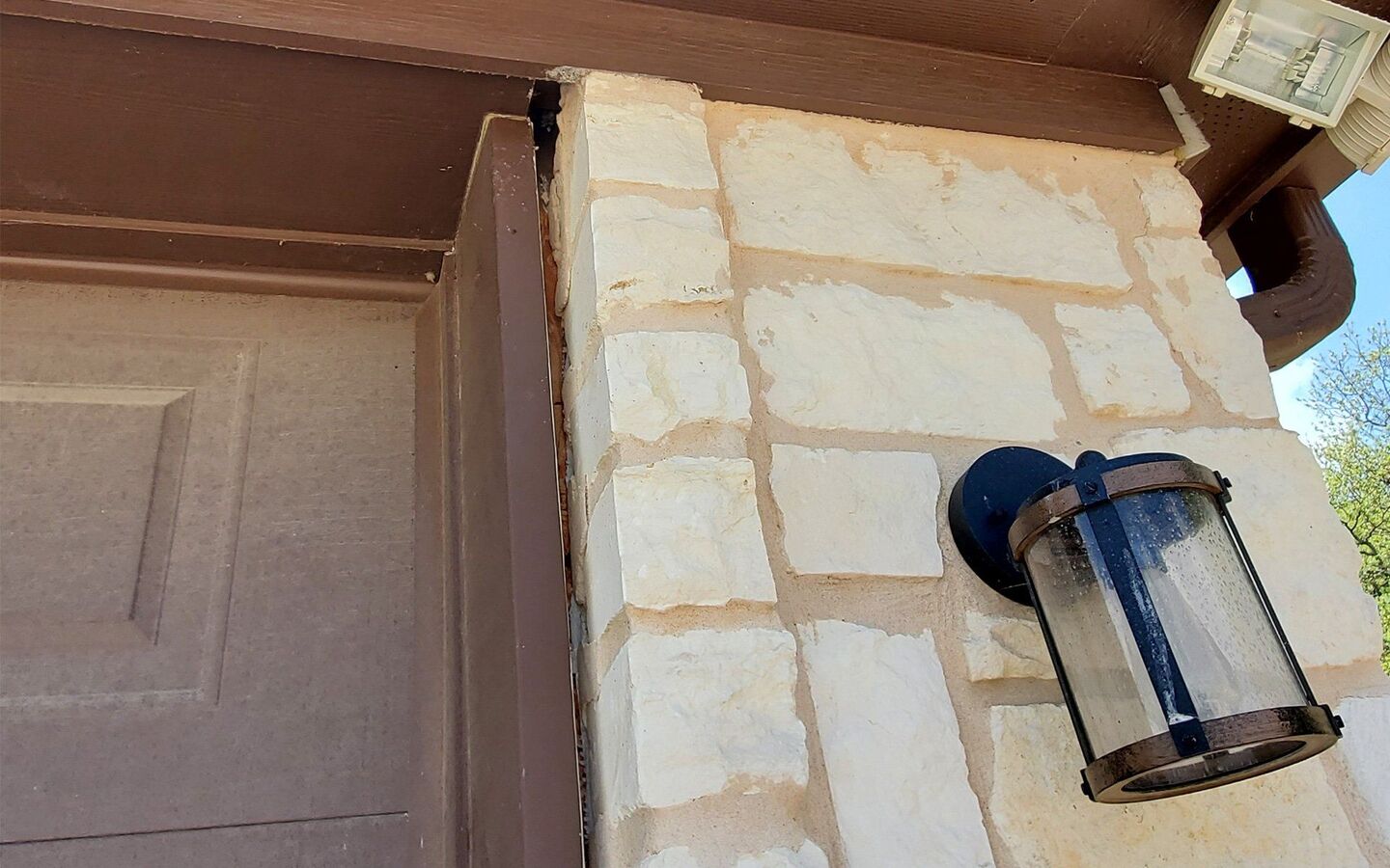 Stone column separating from trim at the corner of a Texas home